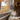 Senior cat in fall looking out the window at autumn leaves
